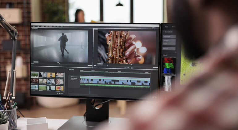 Male videographer editing video montage Male videographer editing video montage on post production software, working on computer. Creating movie content with color grading, edit creative multimedia film footage on app.